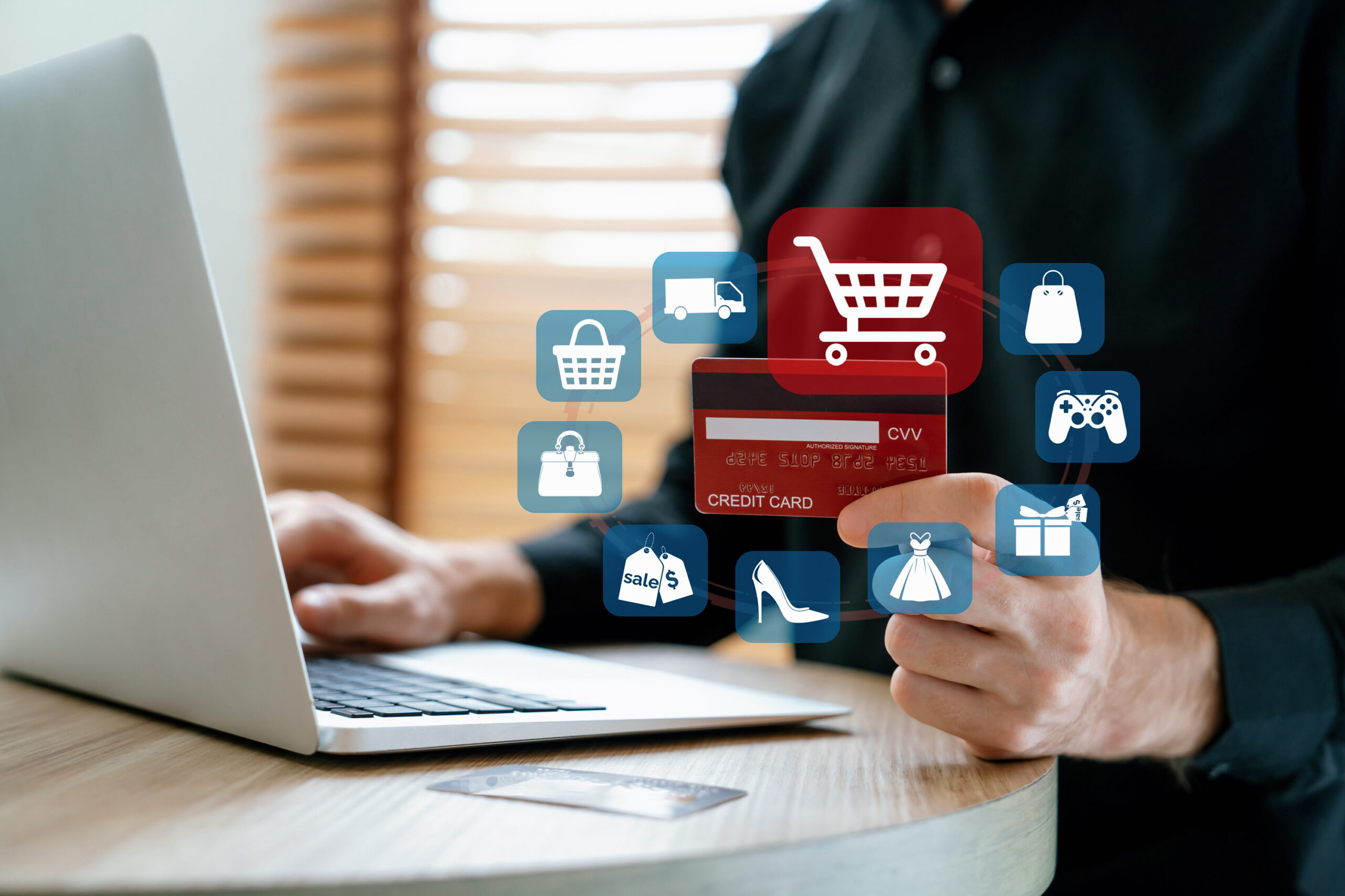 Ein Nutzer hält eine Kreditkarte vor einem Laptop, um online einzukaufen. Digitale Shopping-Icons zeigen den E-Commerce-Prozess. Eine Amazon Agentur hilft Unternehmen, ihre Verkäufe auf Plattformen zu optimieren.